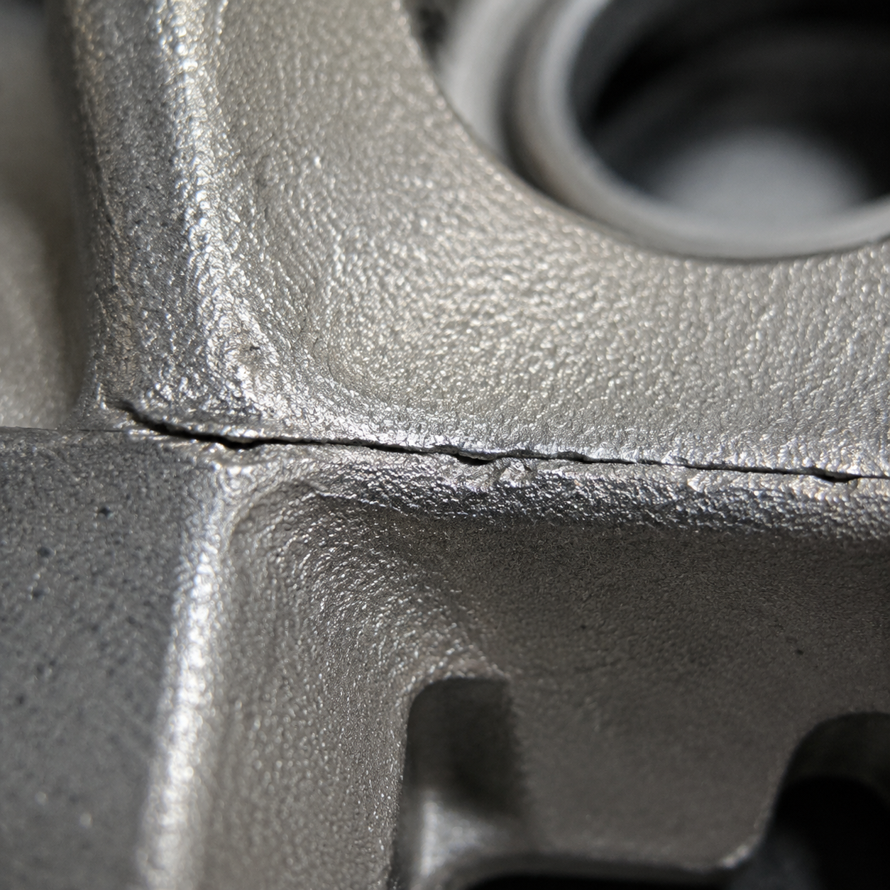 Close-up of a cold shut defect on a steel casting surface