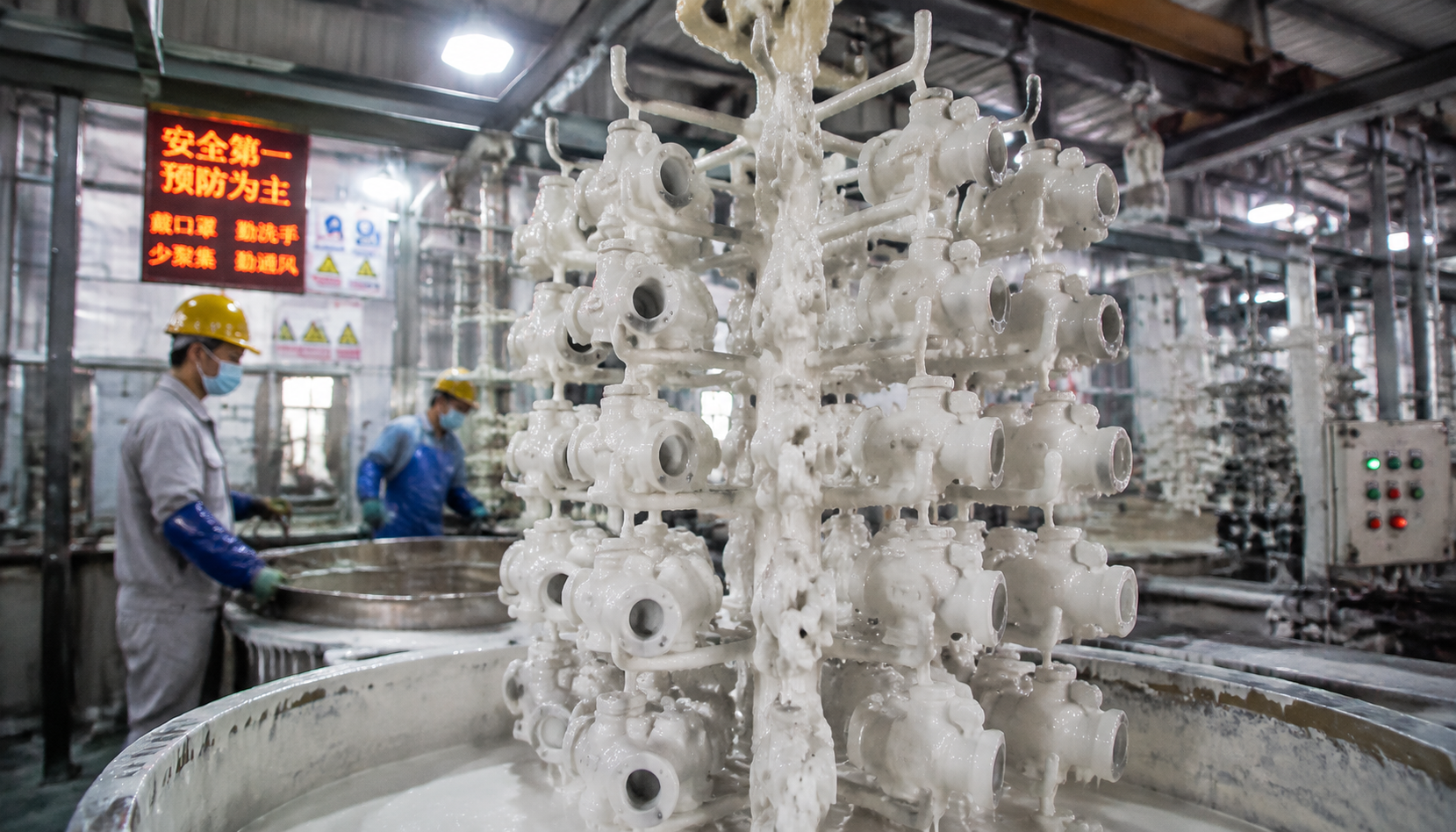 Stainless steel investment castings on a wax tree in a foundry shell room
